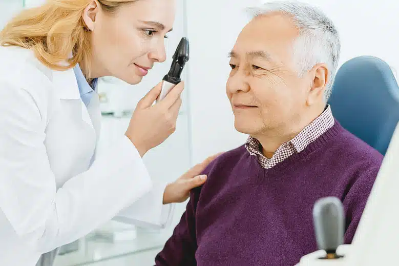 Woman eye doctor performing a glaucoma eye exam after Tube Shunt surgery.